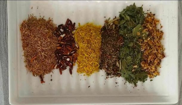 The whole herbs that fill an Oracle's teabag, laid out on a tray